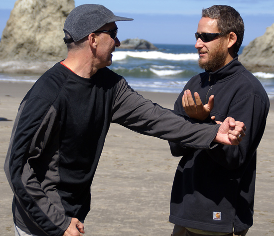 Gene Burnett and Neil Buettner doing tai chi applications on the beach at Bandon.